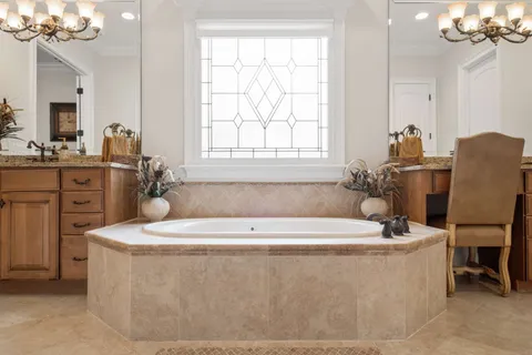 a living room with furniture a flat screen tv and a window