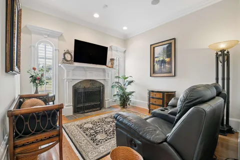 a living room with furniture a lamp and a projector screen