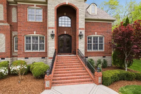 a front view of a house with garden
