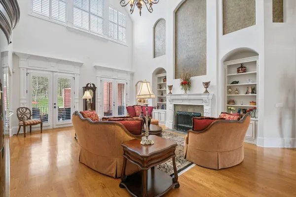 a living room with fireplace furniture and a chandelier