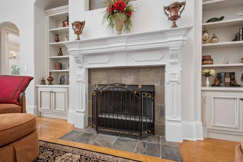a view of a kitchen with kitchen island stainless steel appliances a stove a sink a center island and furniture