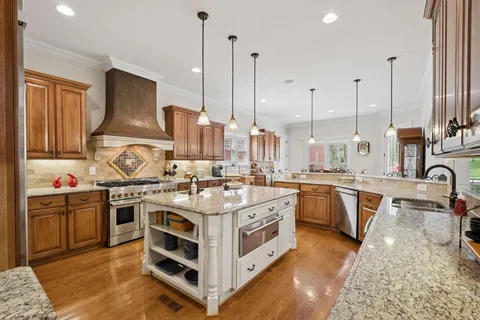 a view of dining table chairs and chandelier