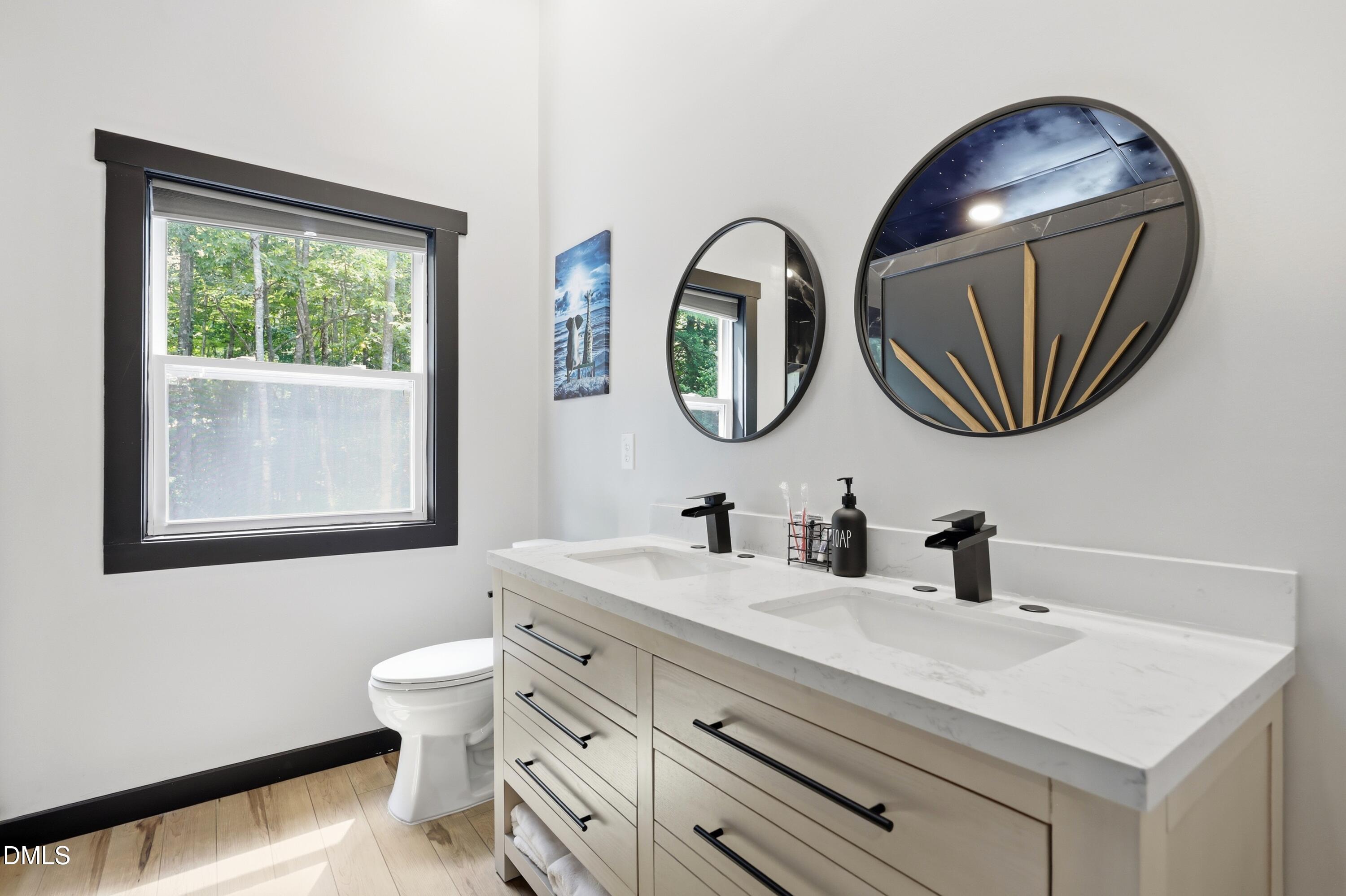 286 Stone Wall Road Pittsboro, NC 27312 - Photo 51 of 71 a bathroom with a toilet sink and mirror