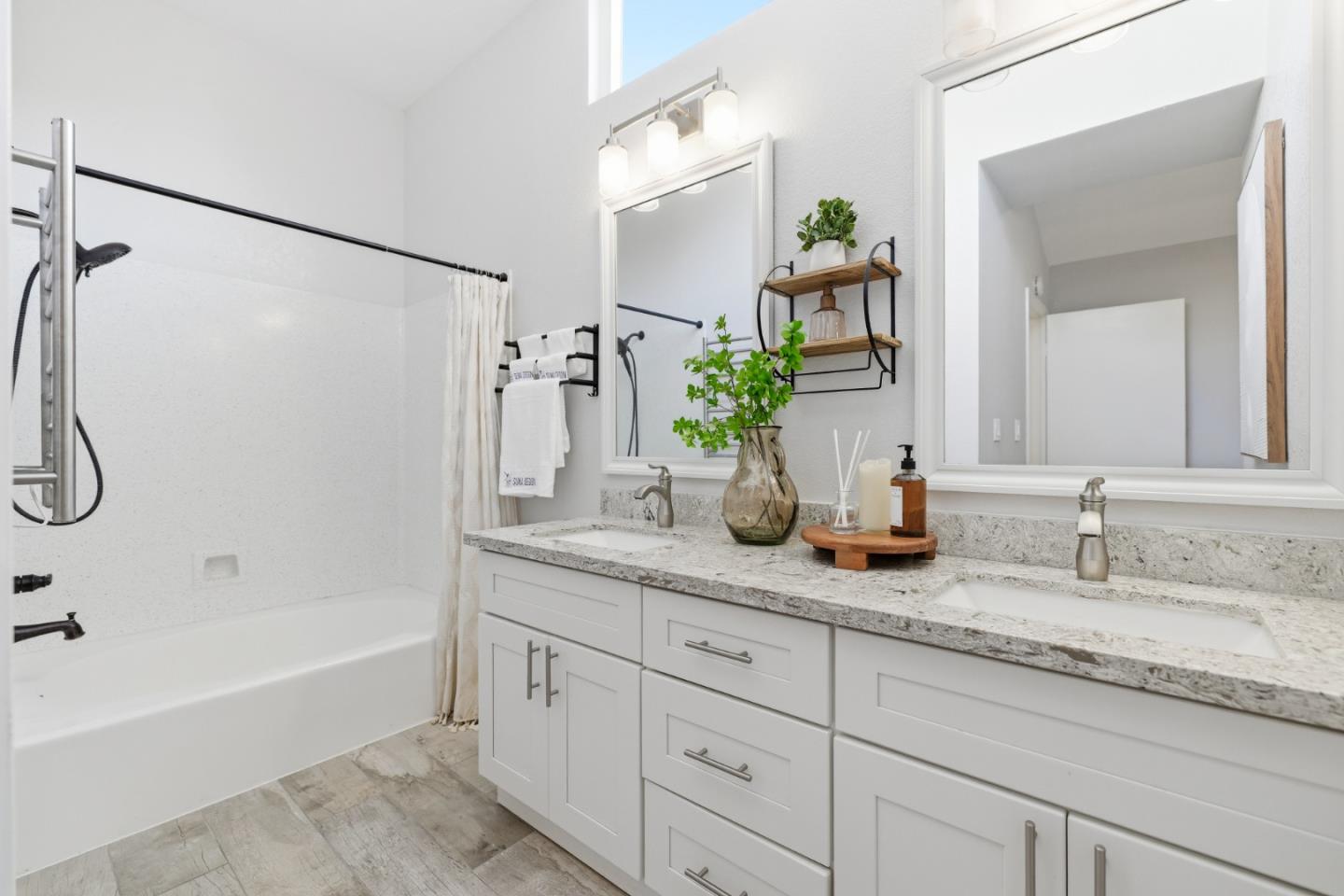 2896 Barrington Terrace Fremont, CA 94536 - Photo 40 of 64 a bathroom with a granite countertop sink a mirror a bathtub and shower