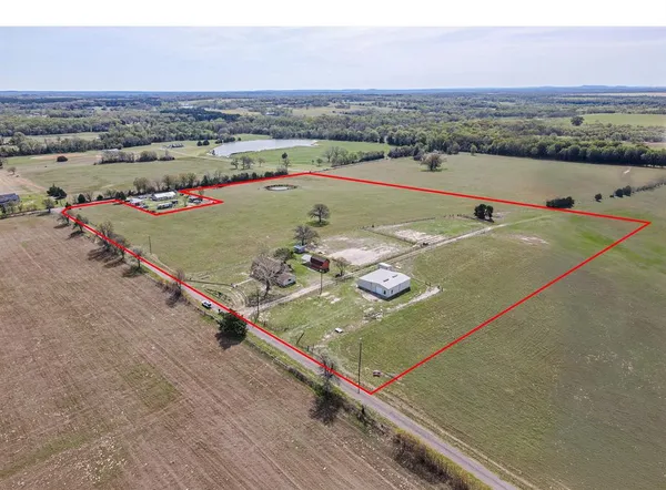 an aerial view of a tennis ground and a mountain view
