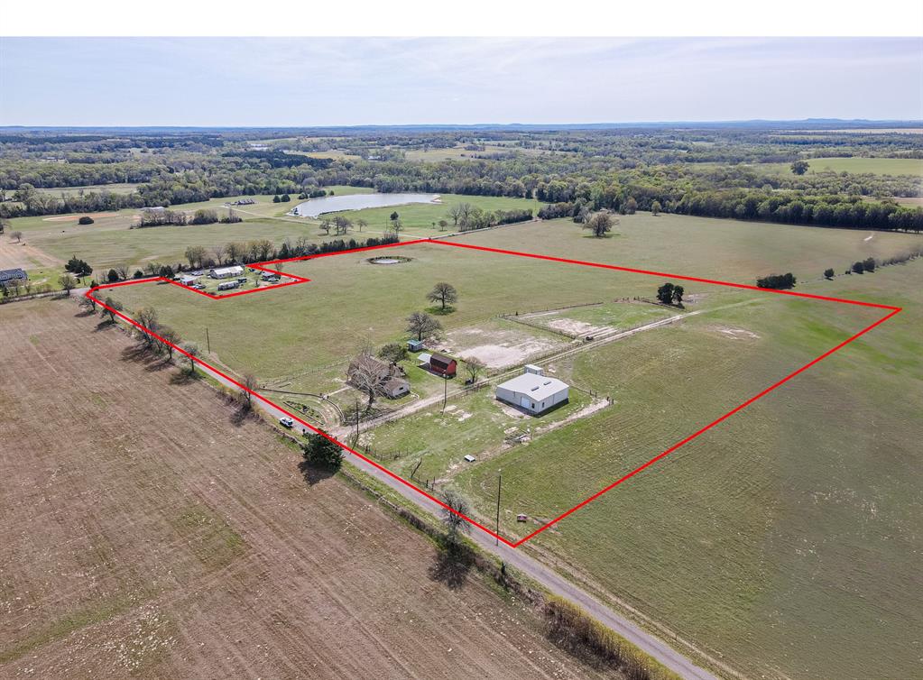an aerial view of a tennis ground and a mountain view