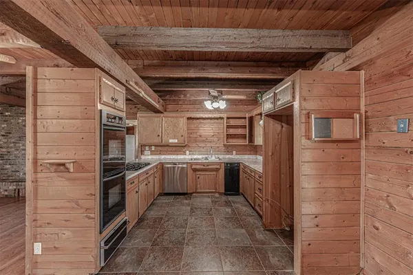 a kitchen with cabinets and stainless steel appliances