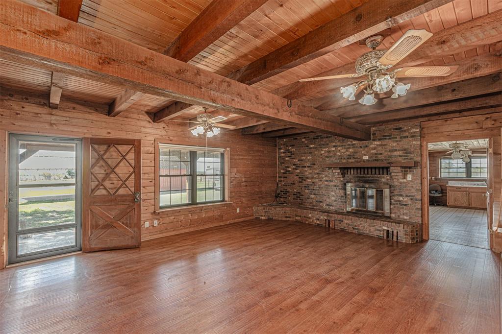 198 VZ County Road Ben Wheeler, TX 75754 - Photo 15 of 40 wooden floor in an empty room with a fireplace