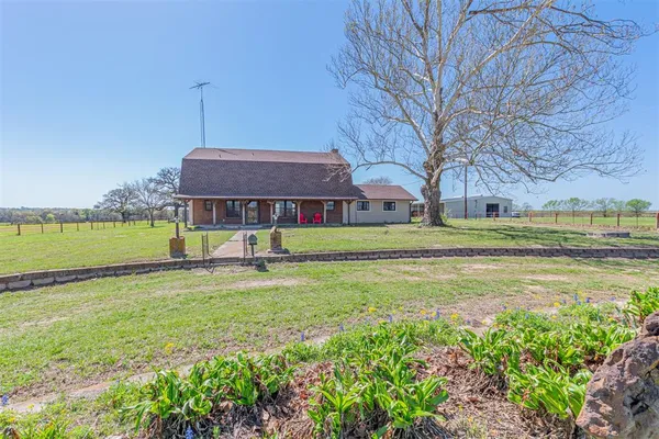 a view of a house with a yard and swimming pool