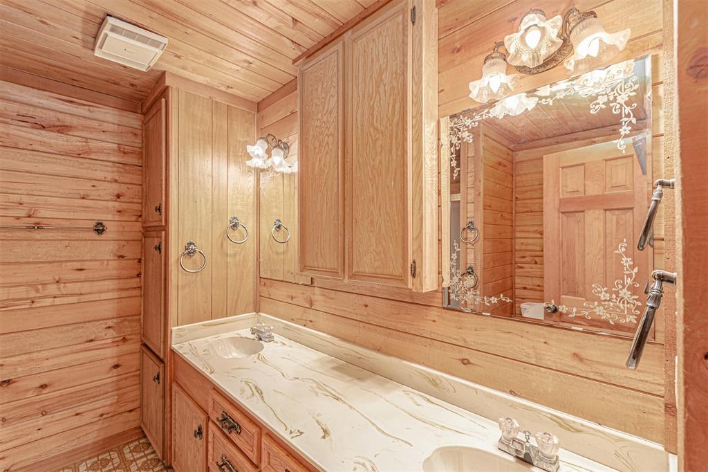 198 VZ County Road Ben Wheeler, TX 75754 - Photo 24 of 40 a bathroom with a granite countertop sink and a mirror