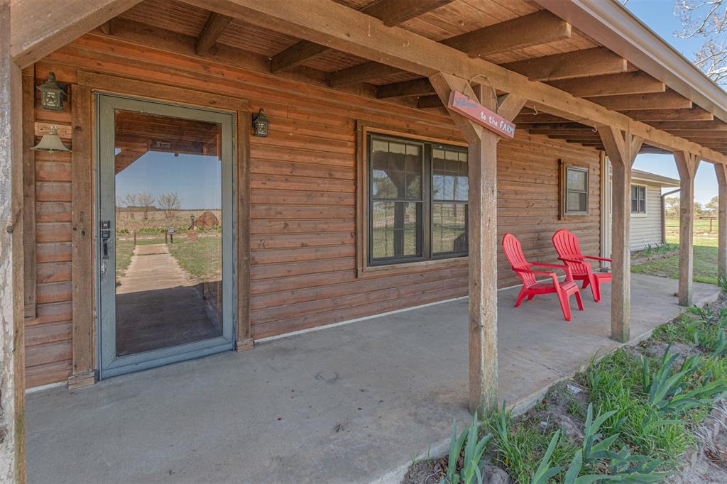 198 VZ County Road Ben Wheeler, TX 75754 - Photo 4 of 40 a view of a porch with a potted plant and floor to ceiling window