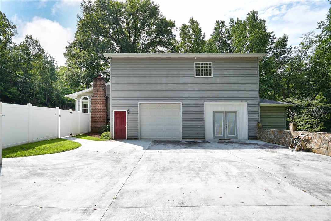 197 Deer Creek Road Easley, SC 29640 - Photo 43 of 50 A robust concrete driveway leads to a property featuring both a garage and a convenient walk-in entry.