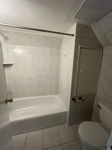 a bathroom with a shower and a toilet