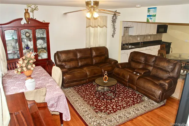 a view of a living room with furniture and a floor to ceiling window