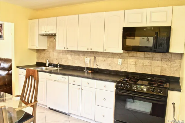 a view of a dining room with furniture and a window