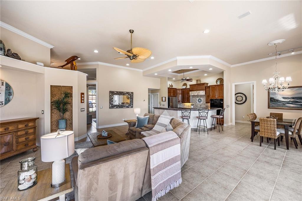 146 Windward Cay Naples, FL 34114 - Photo 8 of 33 a living room with furniture and a chandelier