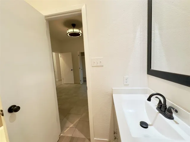 a bathroom with a sink and mirror