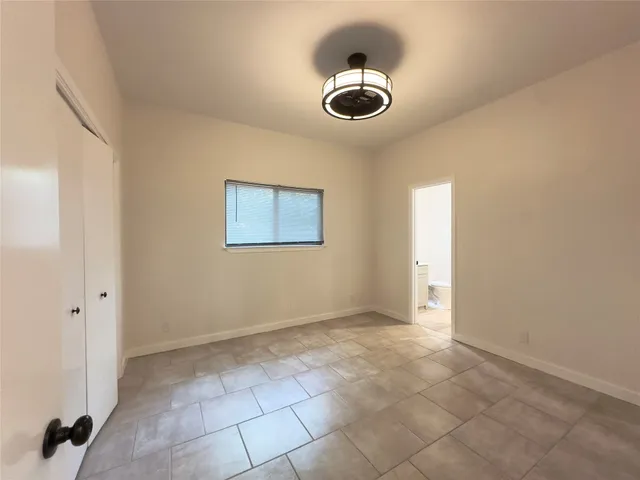 a view of room with a ceiling fan and window