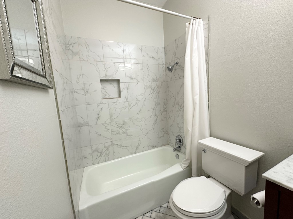 5504 Montview Street, Unit A OR B Austin, TX 78756 - Photo 21 of 27 a white toilet sitting next to a bath tub