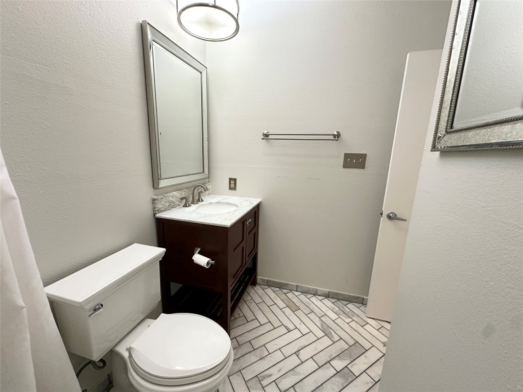 5504 Montview Street, Unit A OR B Austin, TX 78756 - Photo 22 of 27 a bathroom with a toilet sink and mirror