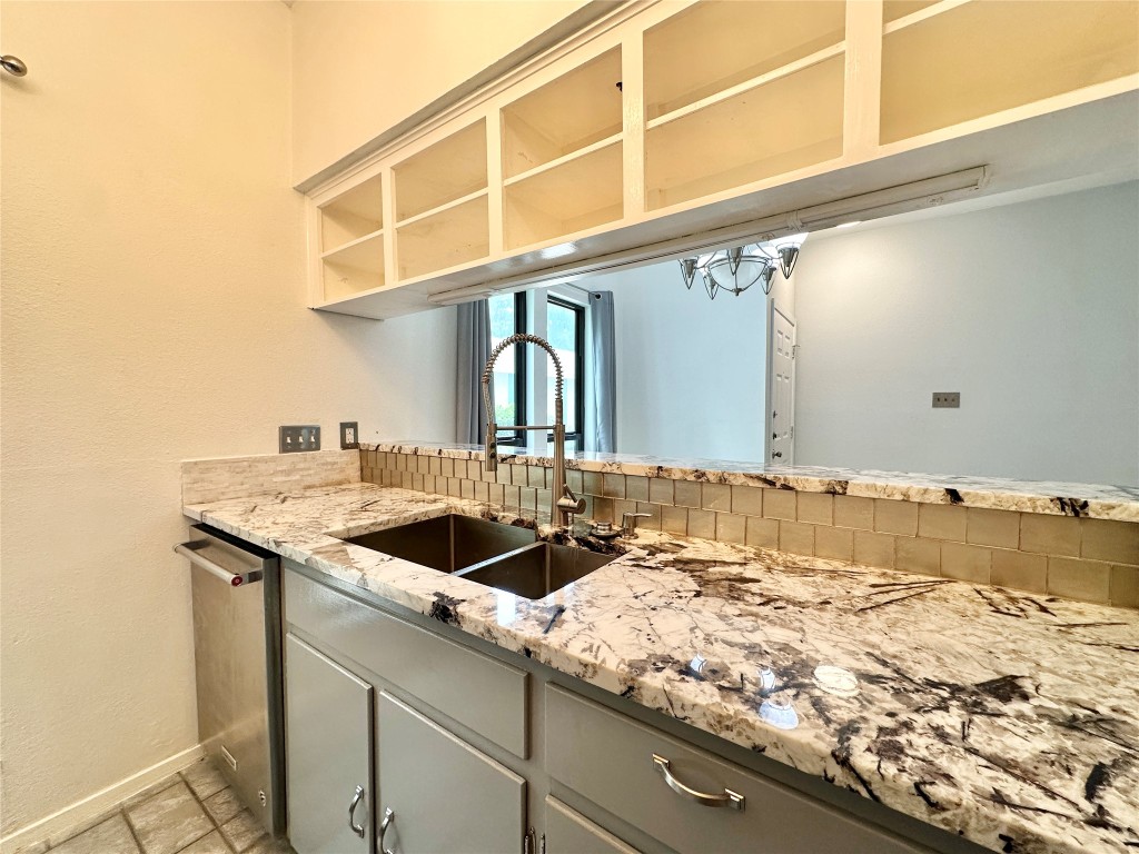 5504 Montview Street, Unit A OR B Austin, TX 78756 - Photo 24 of 27 a bathroom with a granite countertop sink and a large mirror