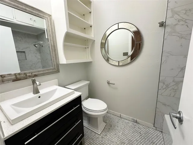 a bathroom with a sink a toilet and a mirror