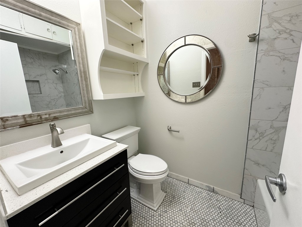5504 Montview Street, Unit A OR B Austin, TX 78756 - Photo 26 of 27 a bathroom with a sink a toilet and a mirror