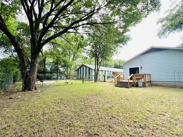 a view of a yard with a house and a tree