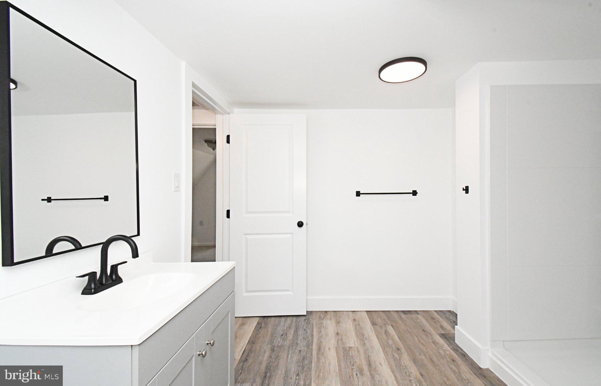 64 North Main Street Spring City, PA 19475 - Photo 20 of 26 Sleek modern bathroom with clean lines.