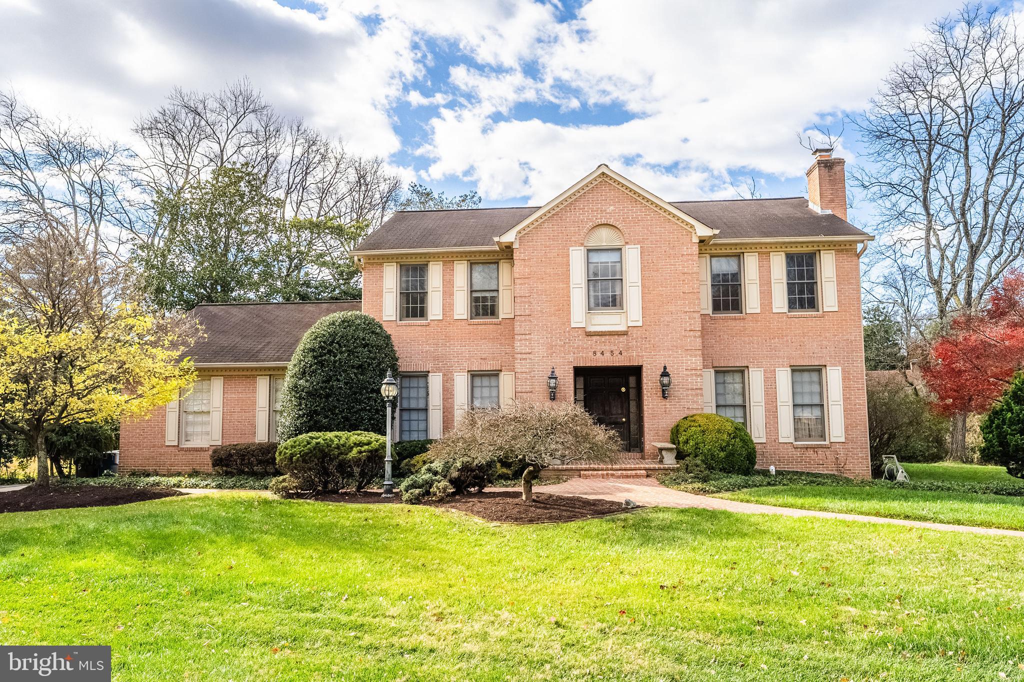 a front view of house with yard and green space
