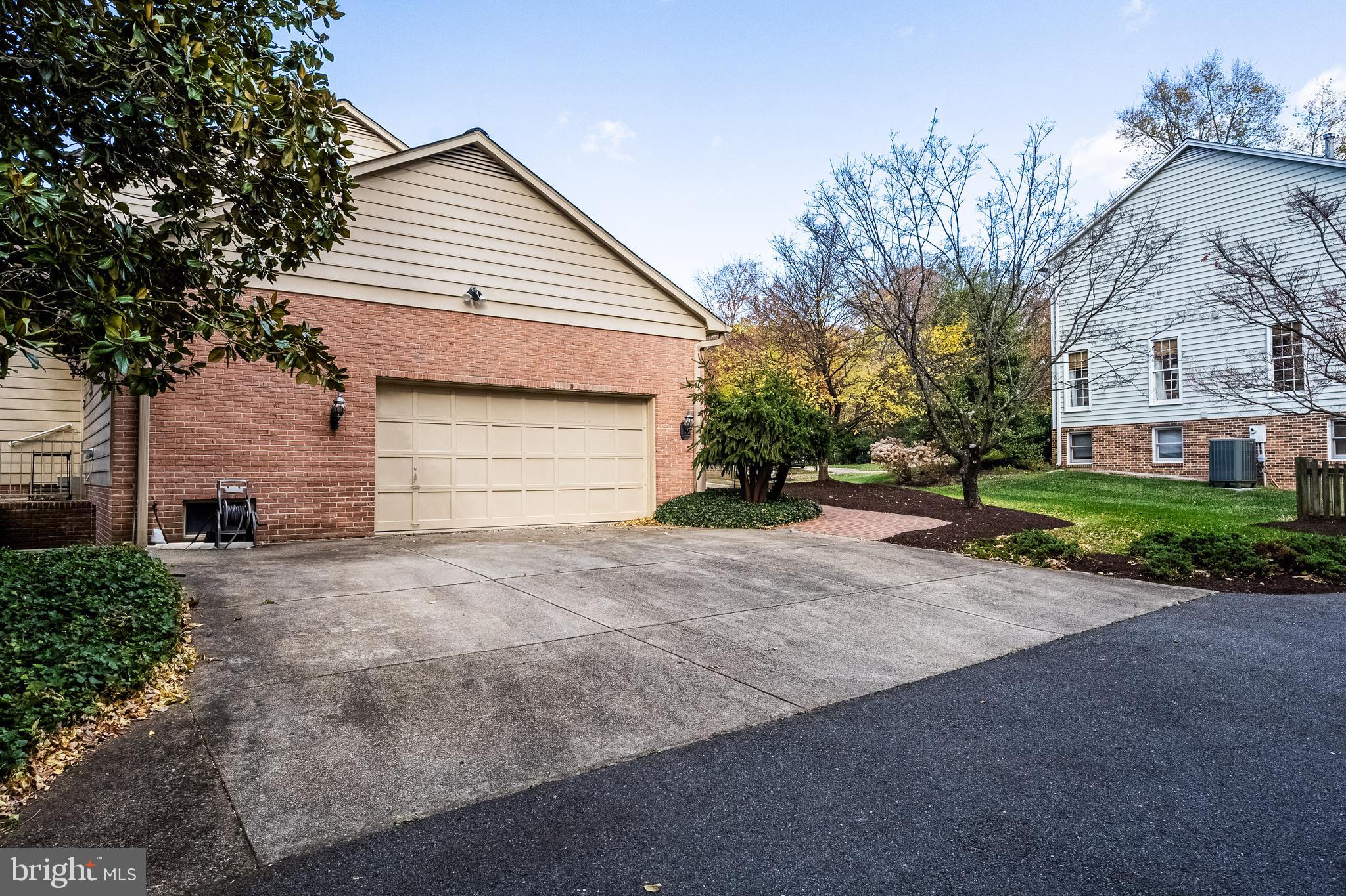 8454 Toll House Road Annandale, VA 22003 - Photo 15 of 65 a front view of a house with a yard and garage