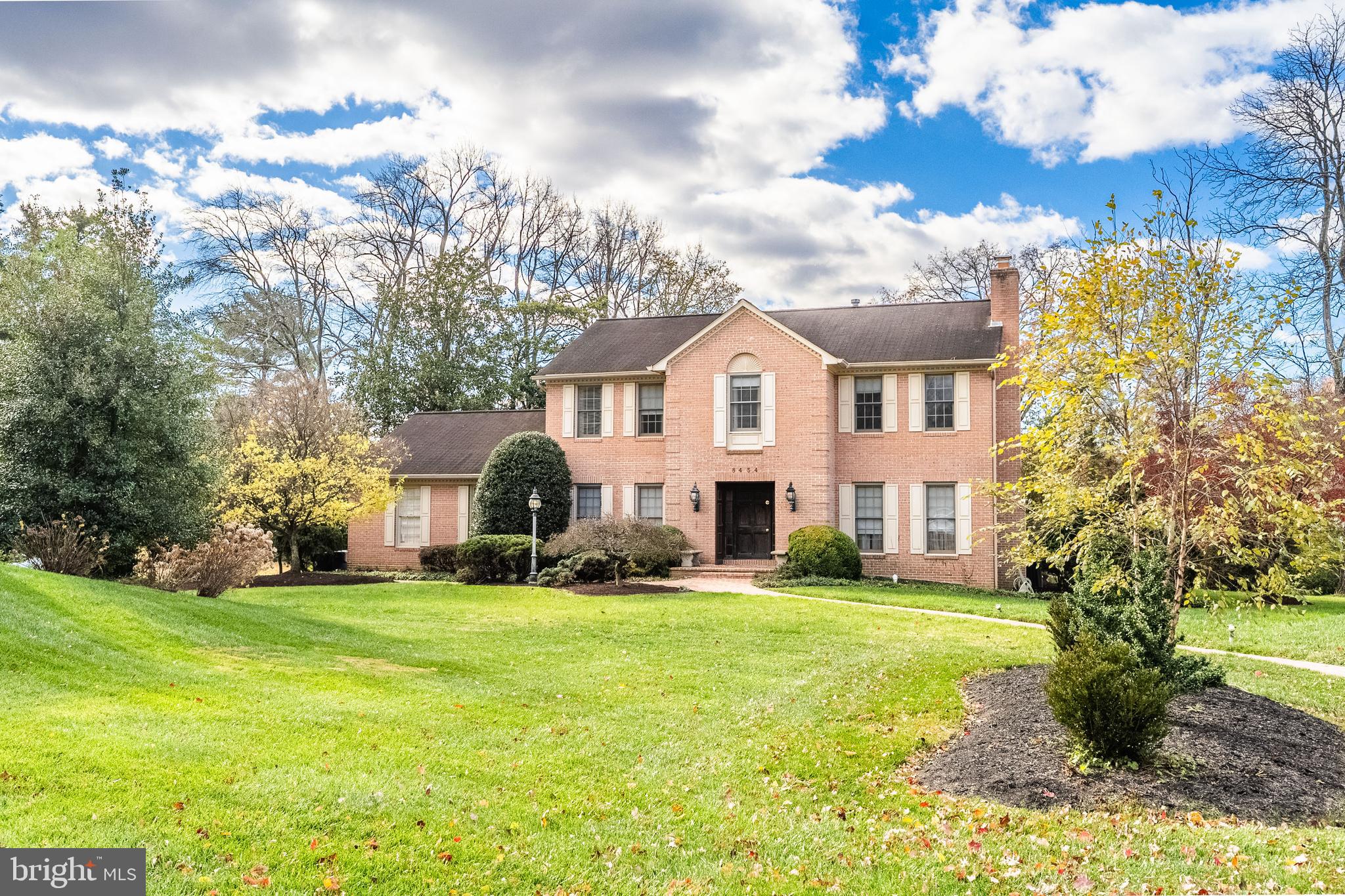 8454 Toll House Road Annandale, VA 22003 - Photo 17 of 65 a view of a white house with a big yard and large trees