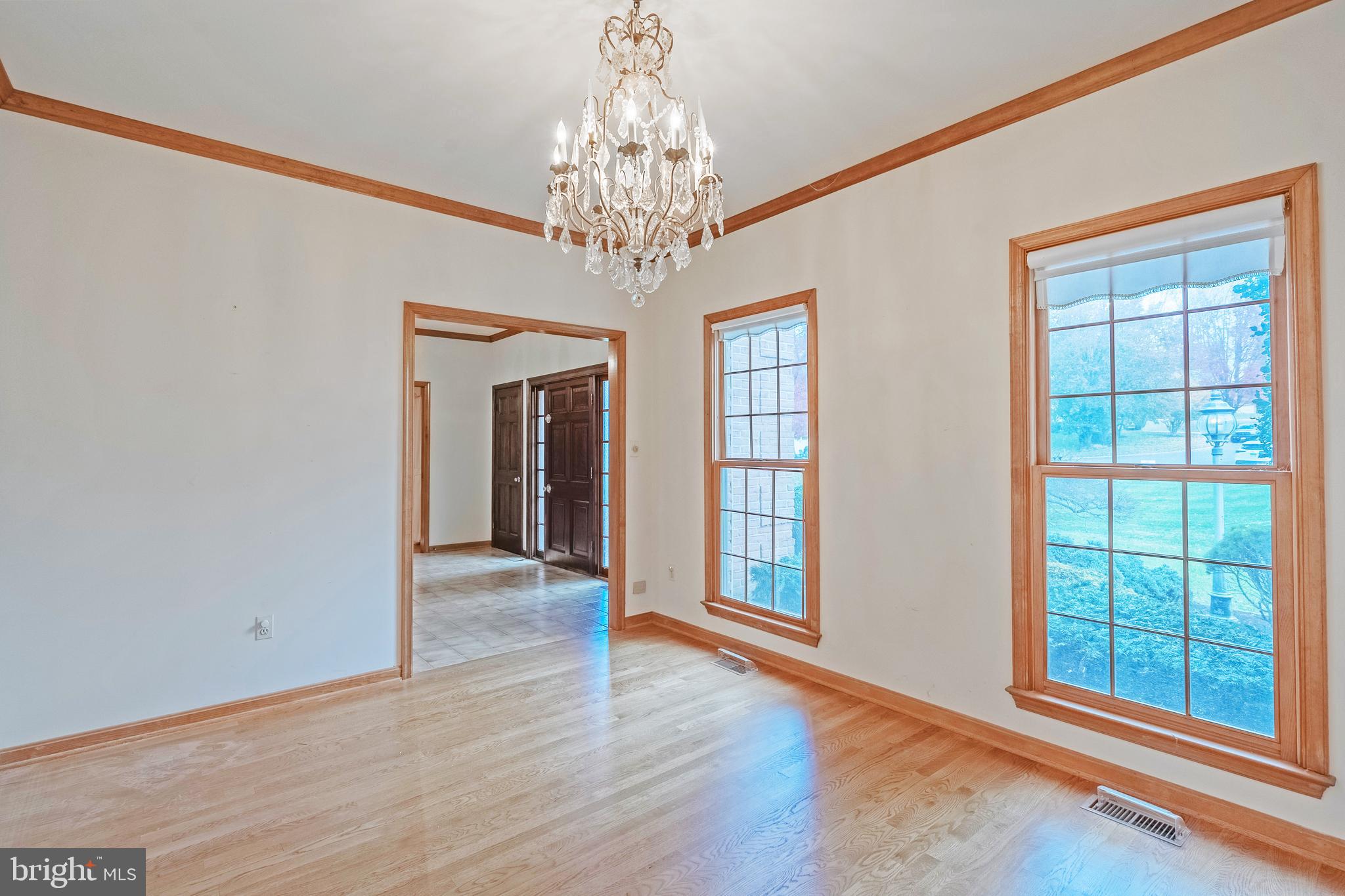 8454 Toll House Road Annandale, VA 22003 - Photo 23 of 65 a view of an empty room with wooden floor and a window