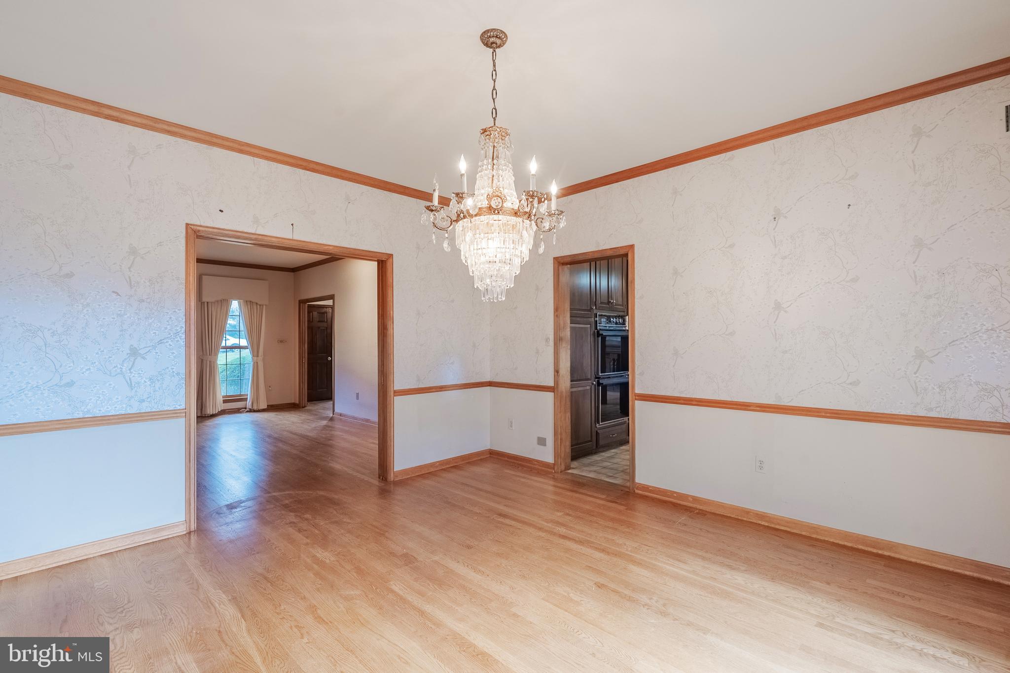 8454 Toll House Road Annandale, VA 22003 - Photo 27 of 65 a view of a hallway with wooden floor and chandelier