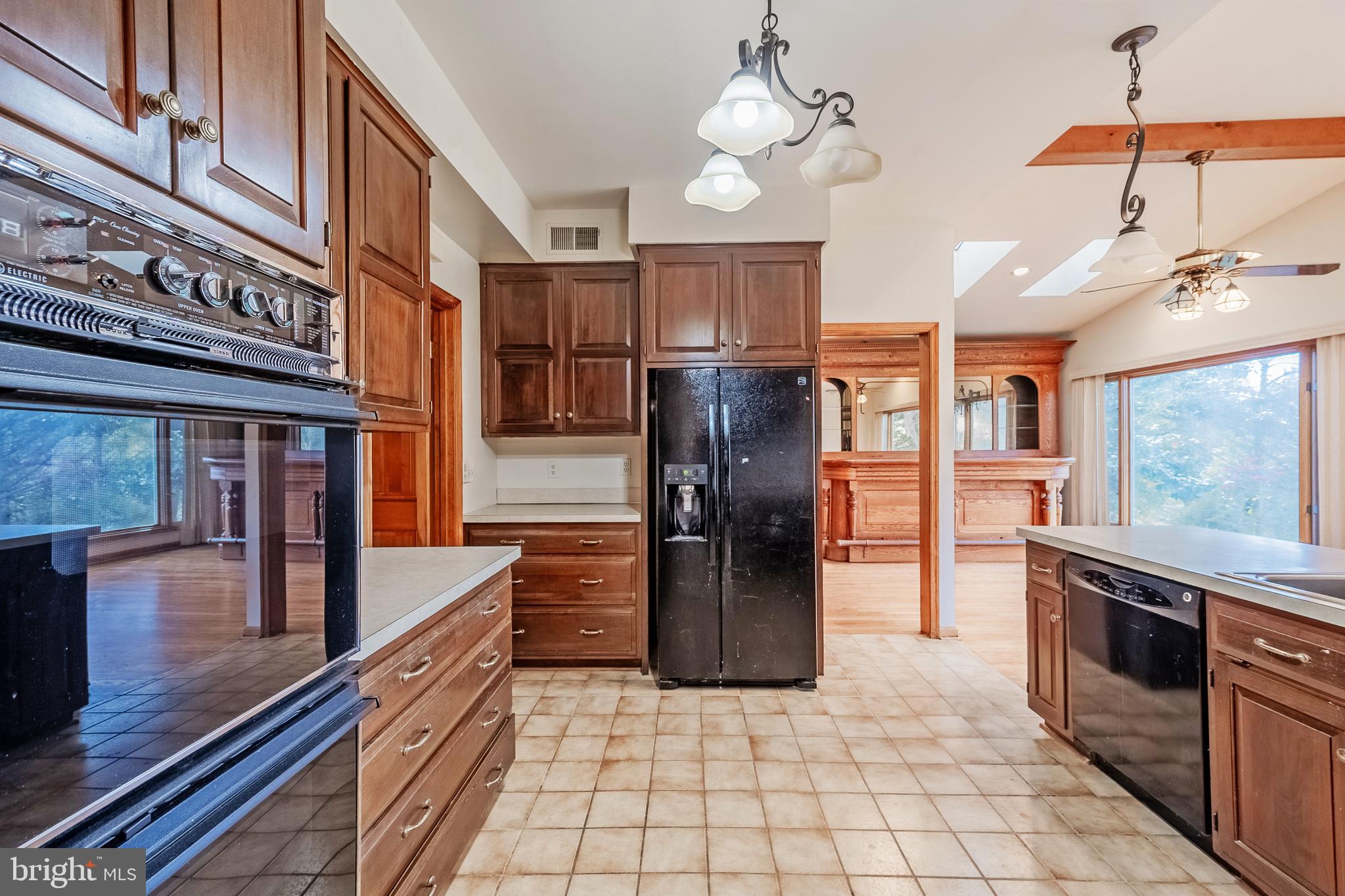 8454 Toll House Road Annandale, VA 22003 - Photo 28 of 65 a kitchen with stainless steel appliances granite countertop a refrigerator a oven a stove and a sink with granite countertops