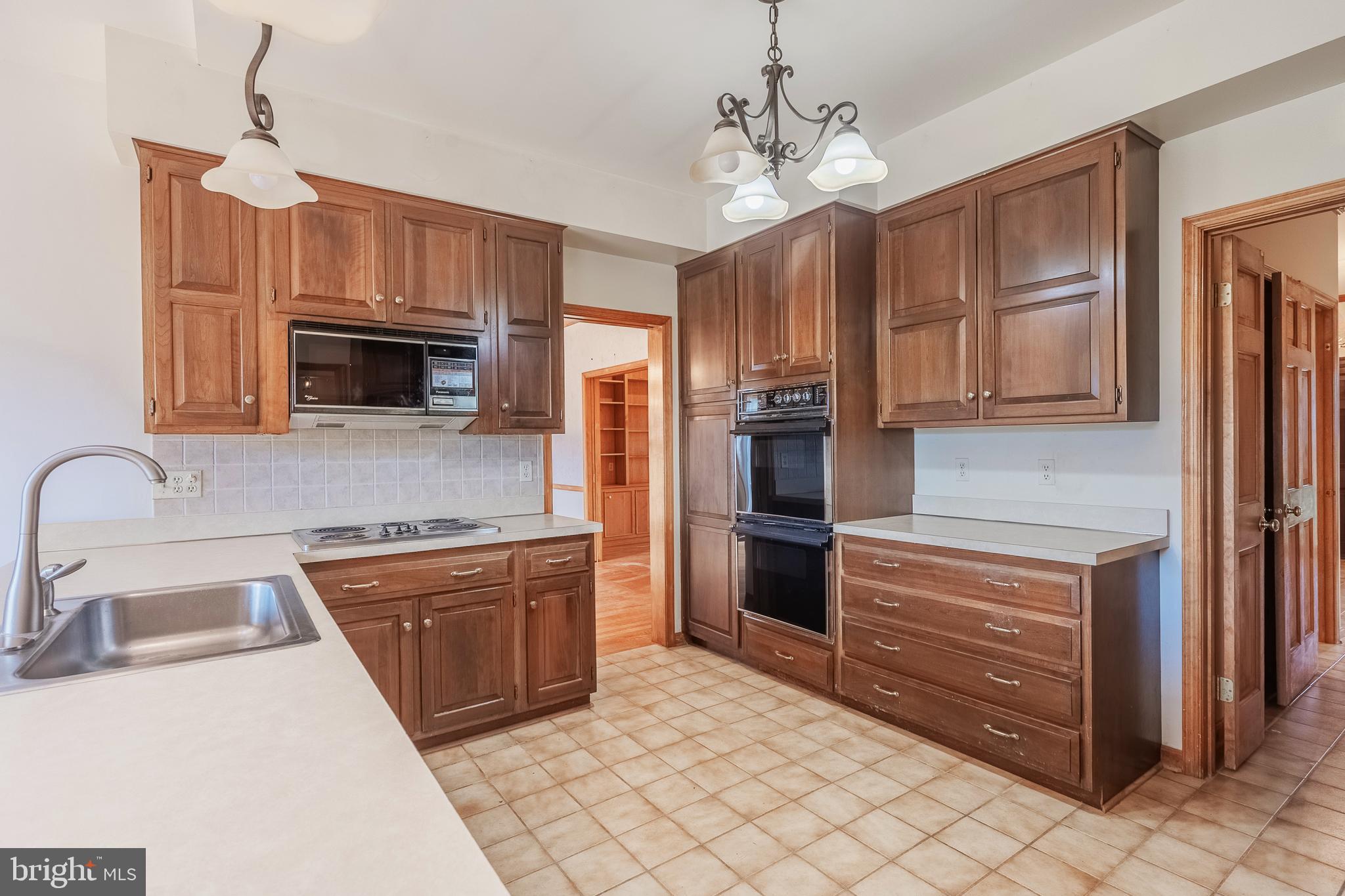 8454 Toll House Road Annandale, VA 22003 - Photo 30 of 65 a kitchen with stainless steel appliances granite countertop a refrigerator and a stove top oven