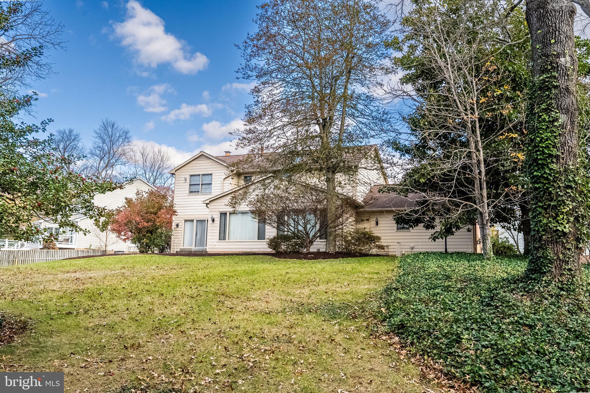 8454 Toll House Road Annandale, VA 22003 - Photo 3 of 65 a view of a house with a big yard and large trees