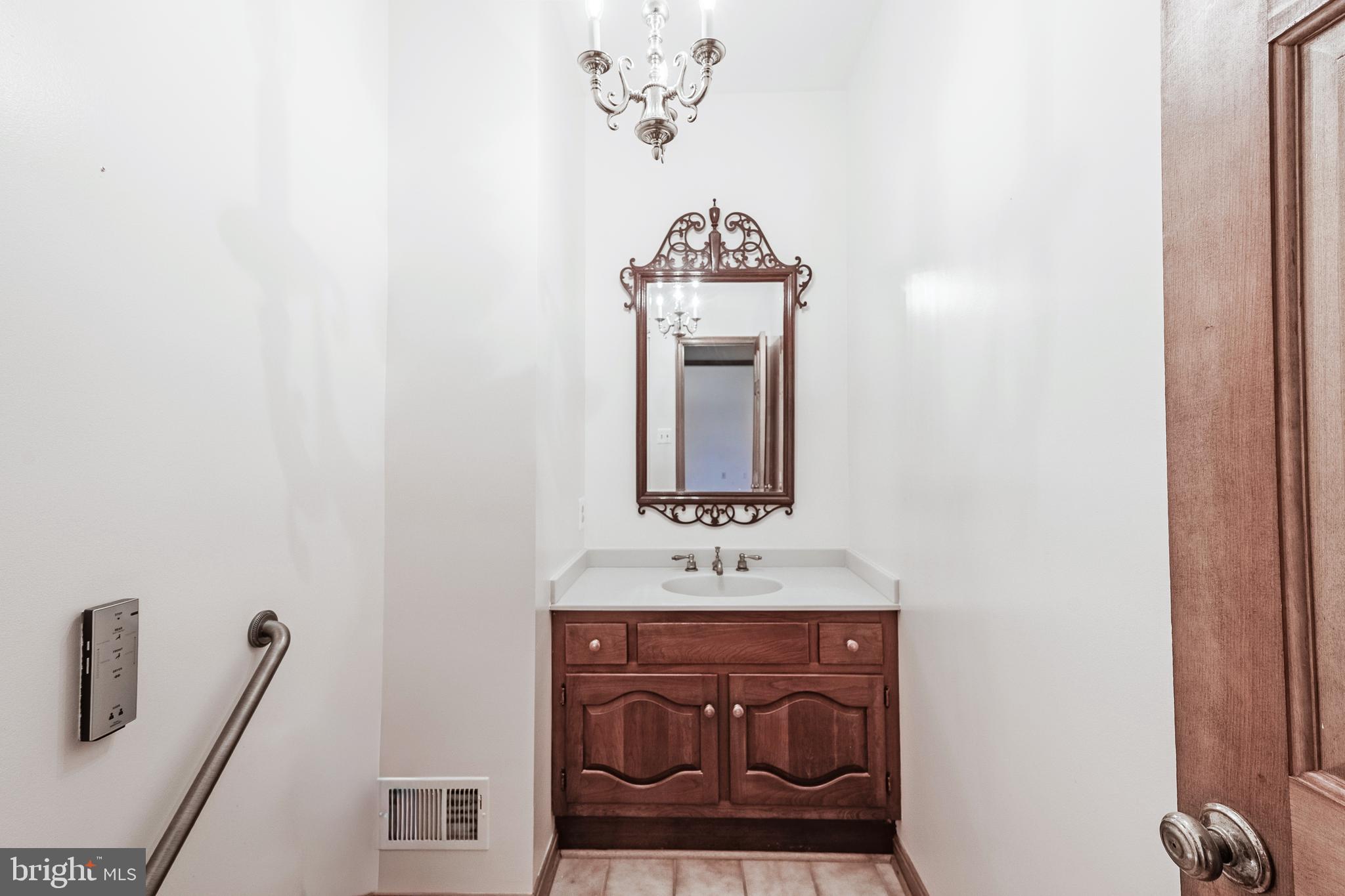 8454 Toll House Road Annandale, VA 22003 - Photo 39 of 65 a bathroom with a sink and a mirror