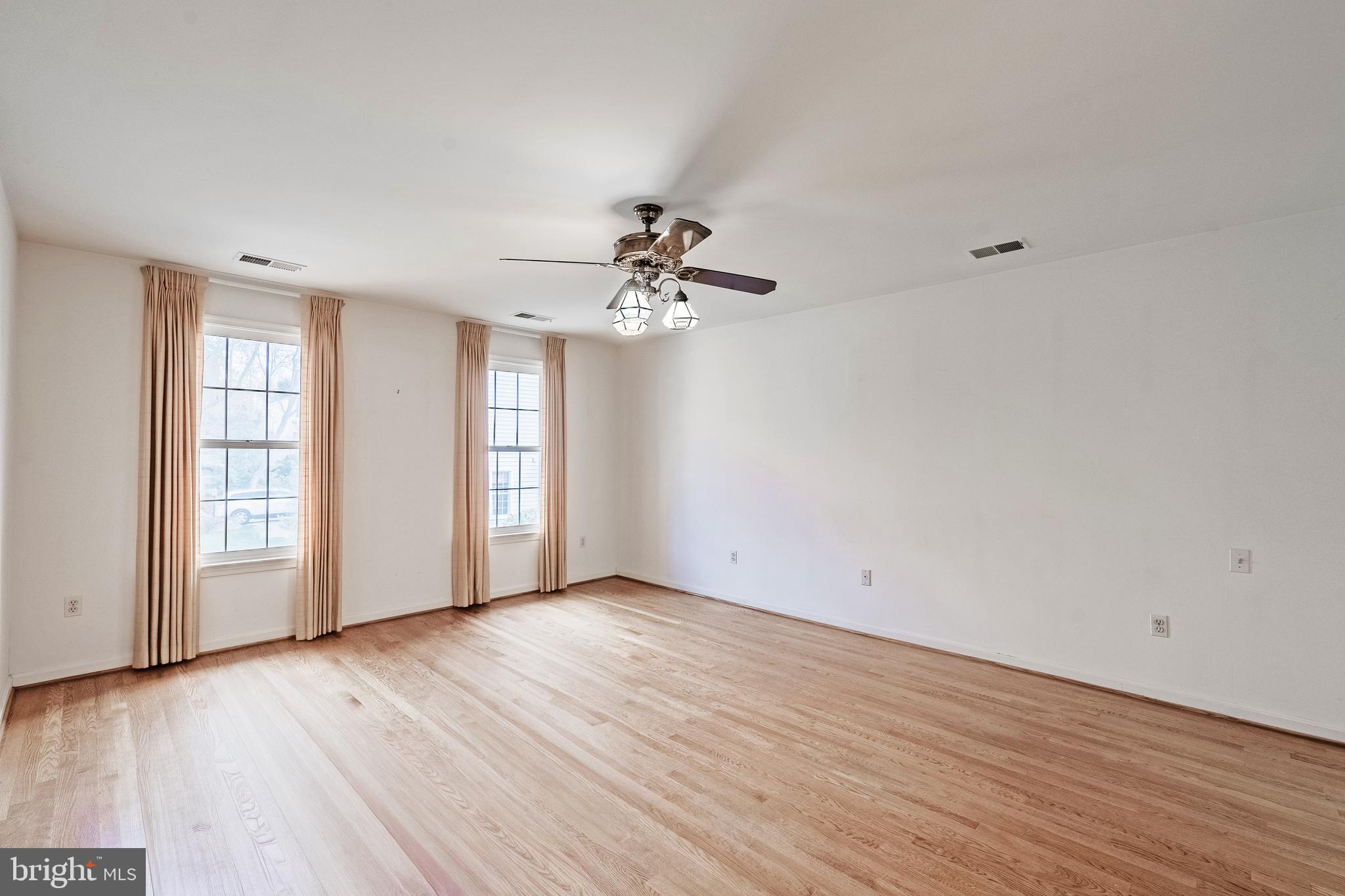 8454 Toll House Road Annandale, VA 22003 - Photo 40 of 65 a view of an empty room with wooden floor and a window