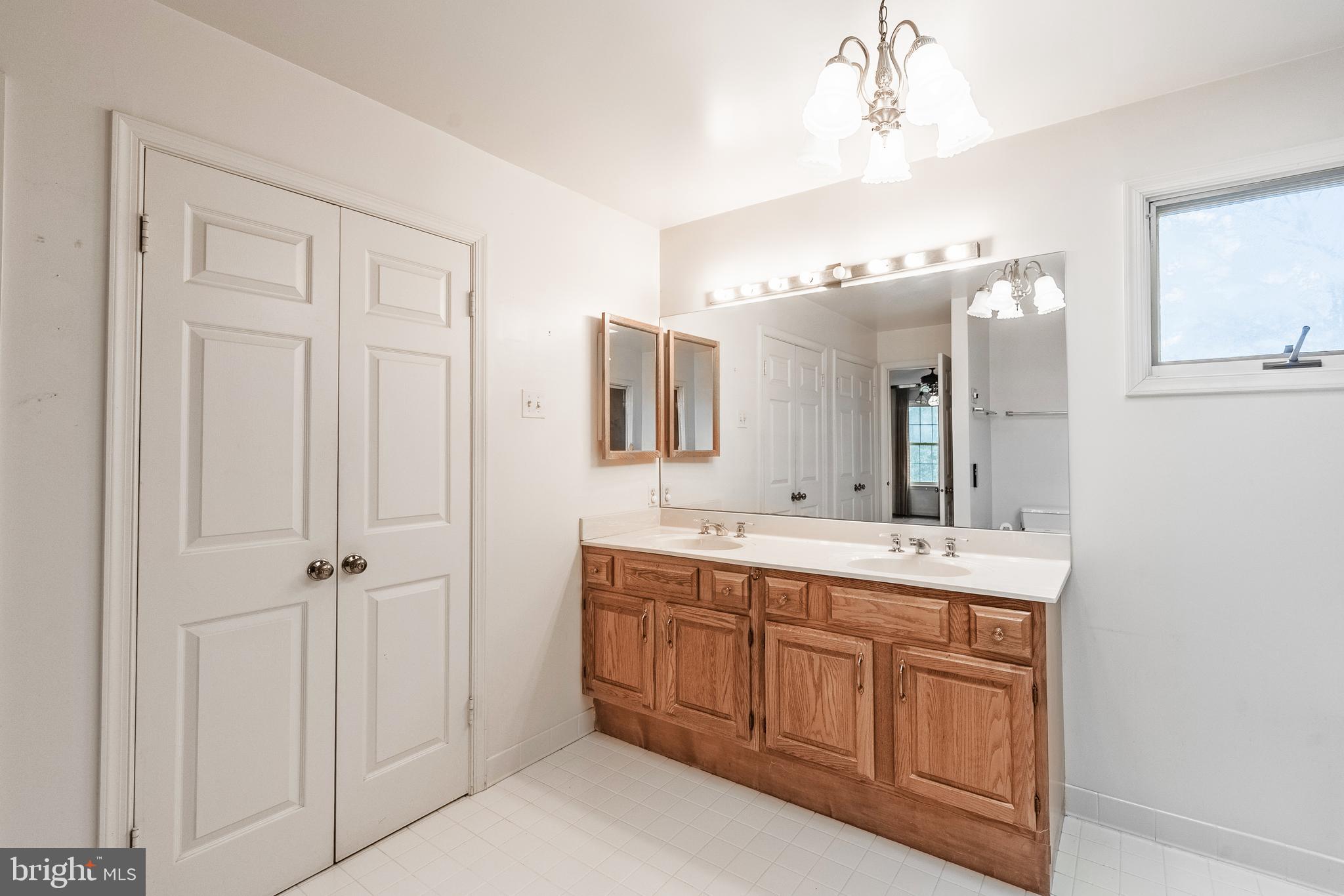 8454 Toll House Road Annandale, VA 22003 - Photo 43 of 65 a spacious bathroom with a double vanity sink a mirror and a