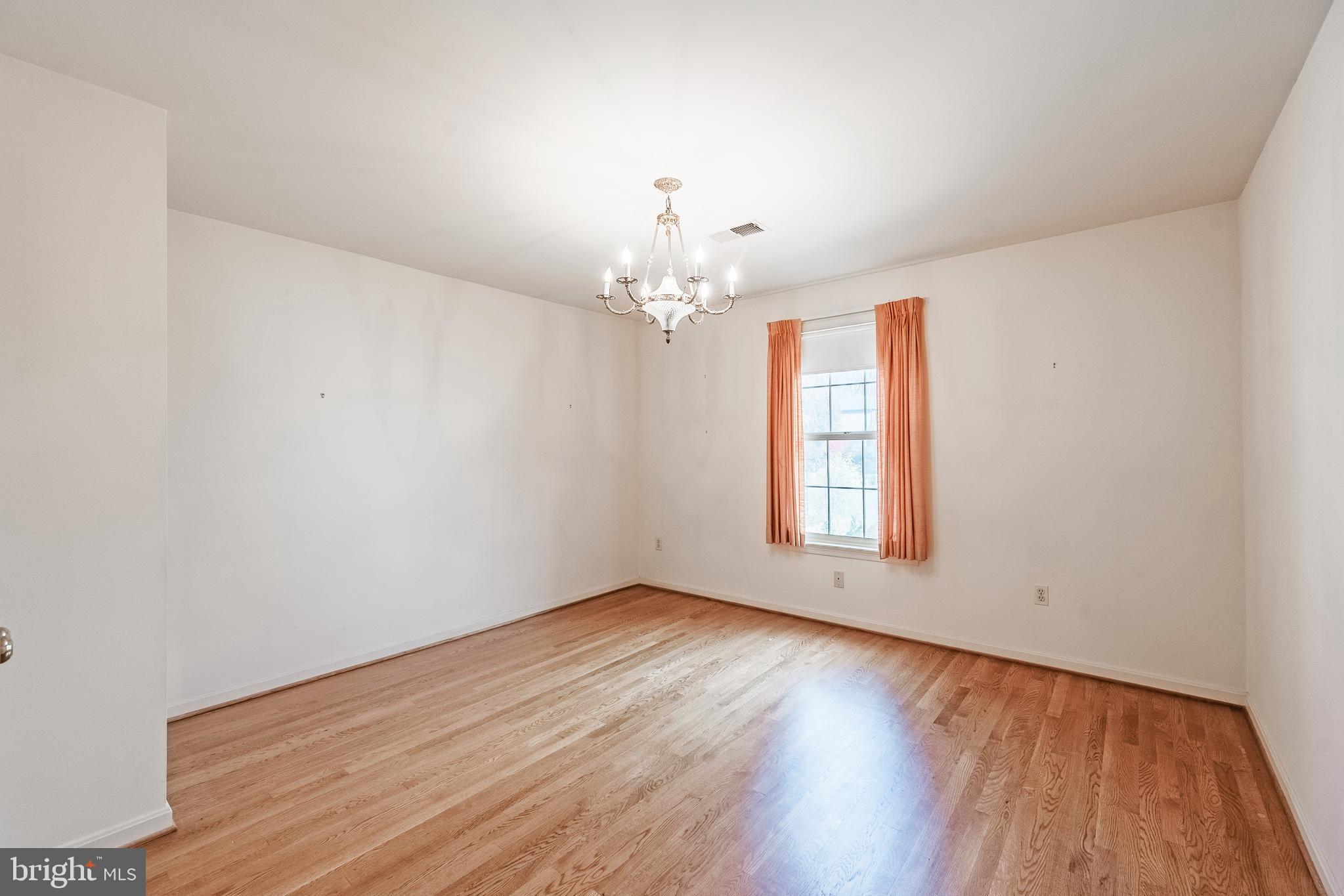 8454 Toll House Road Annandale, VA 22003 - Photo 47 of 65 wooden floor in an empty room with a window
