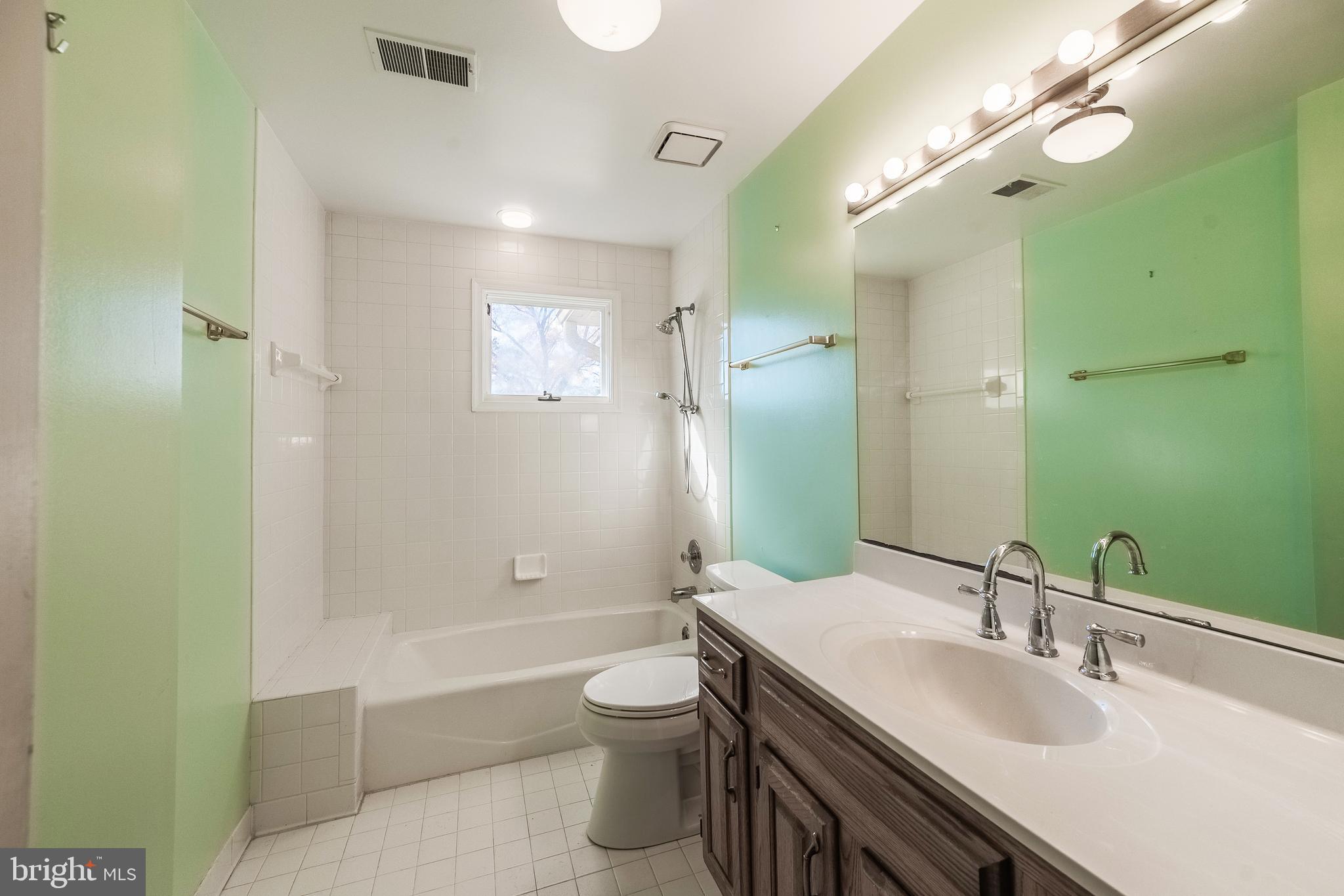 8454 Toll House Road Annandale, VA 22003 - Photo 48 of 65 a bathroom with a double vanity sink toilet mirror and bathtub