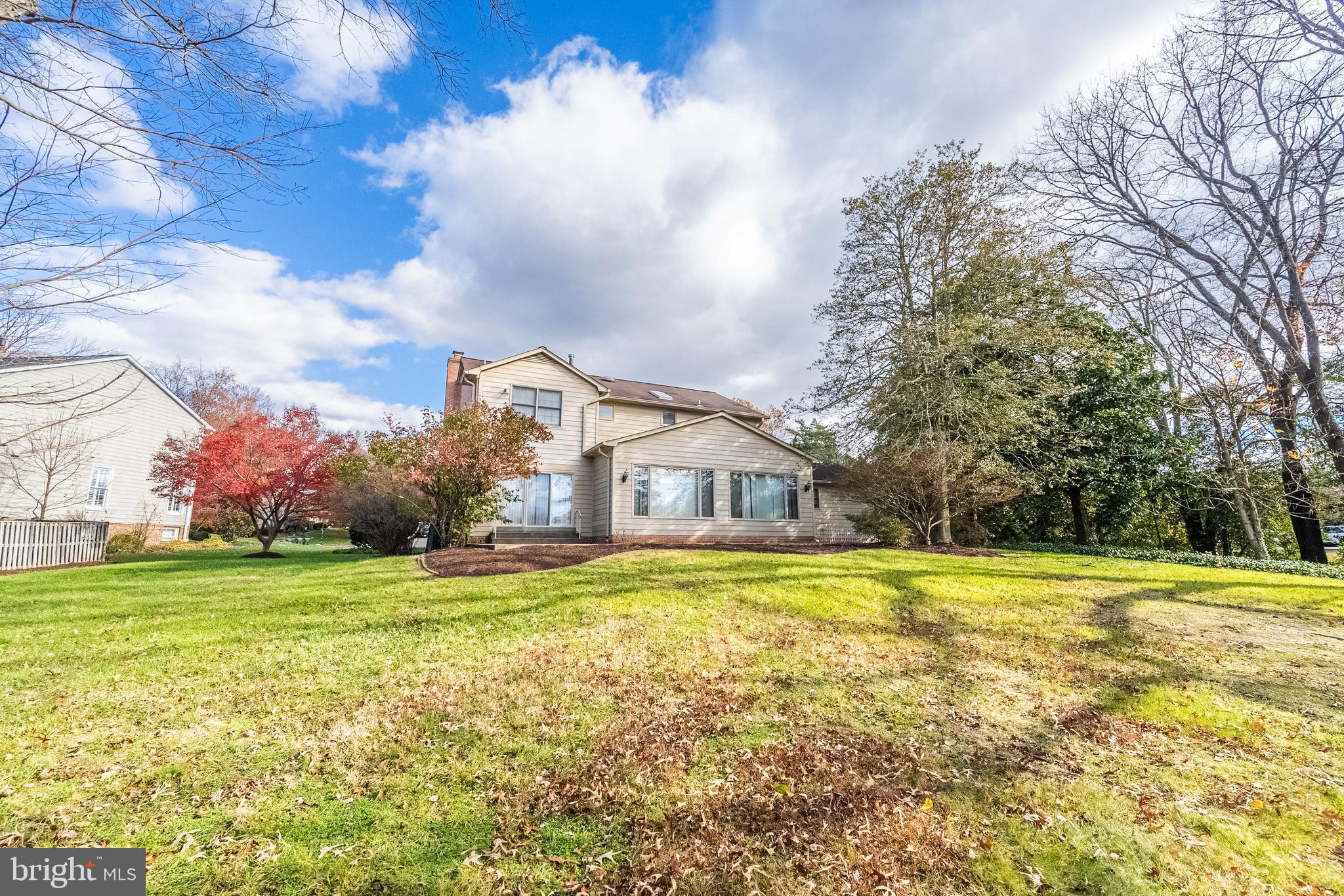 8454 Toll House Road Annandale, VA 22003 - Photo 5 of 65 a view of a house with a big yard and a large tree