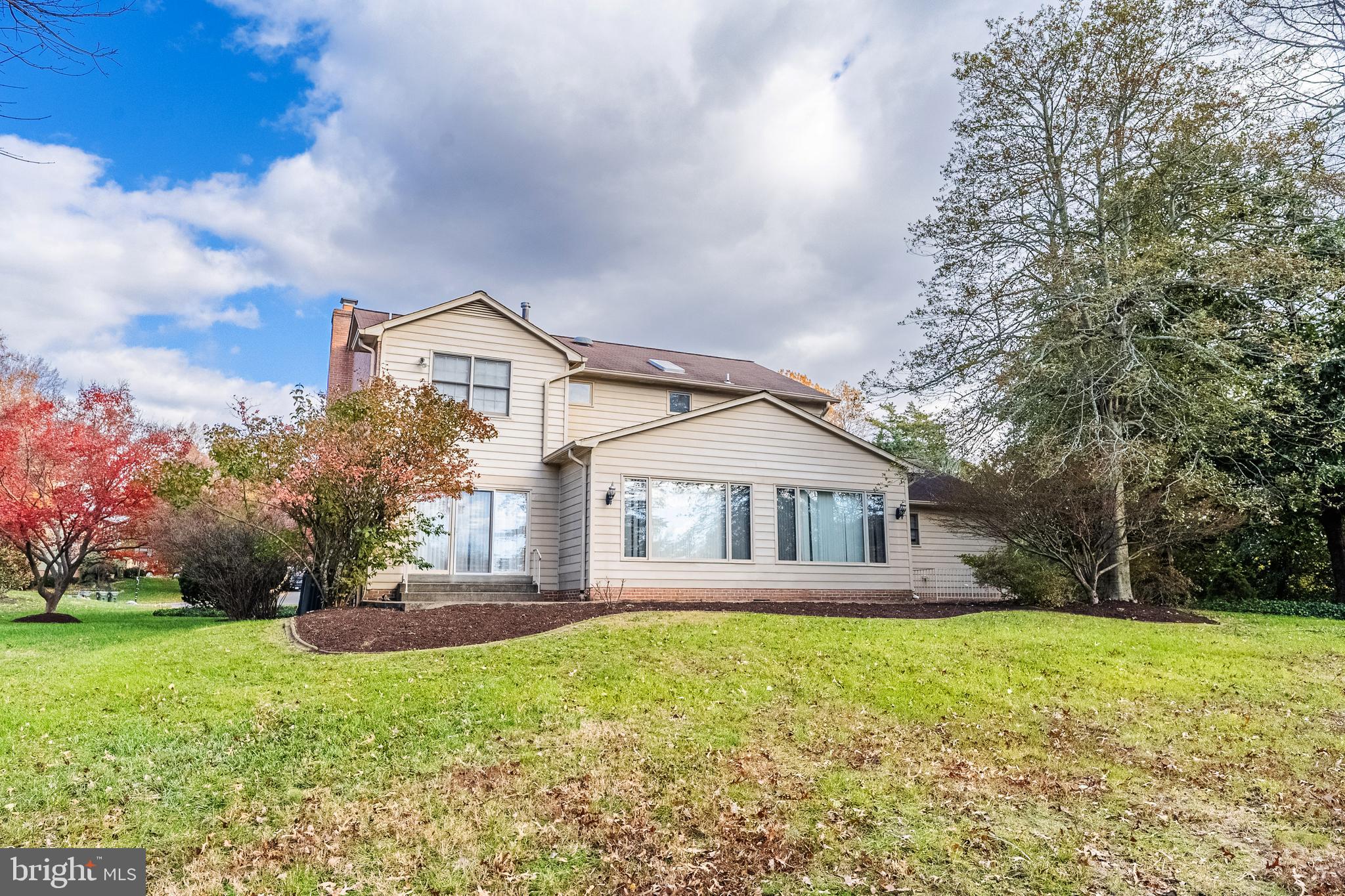 8454 Toll House Road Annandale, VA 22003 - Photo 6 of 65 a front view of a house with a yard and trees