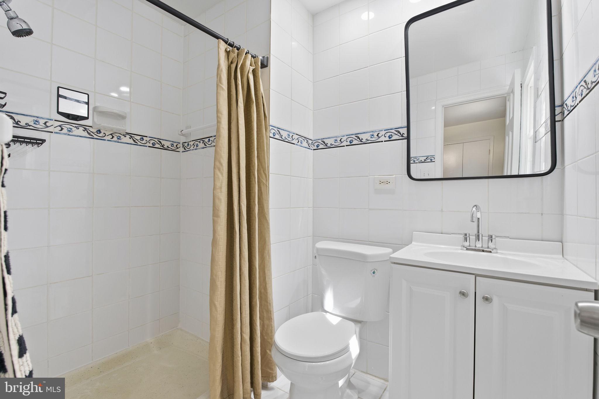 15101 Redgate Drive Silver Spring, MD 20905 - Photo 25 of 39 a bathroom with a granite countertop sink toilet and shower