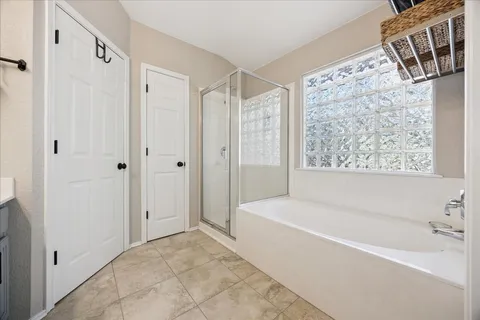 a bathroom with a bathtub and shower