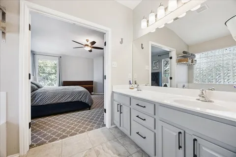 a bedroom with a large bed and a chandelier