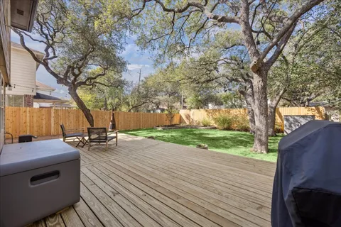 a view of a backyard with wooden fence