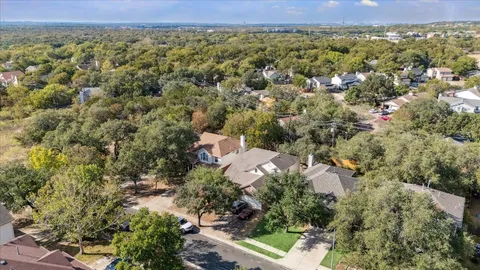 an aerial view of a house with a yard