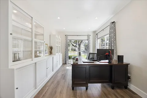 a view of a workspace with furniture and a window